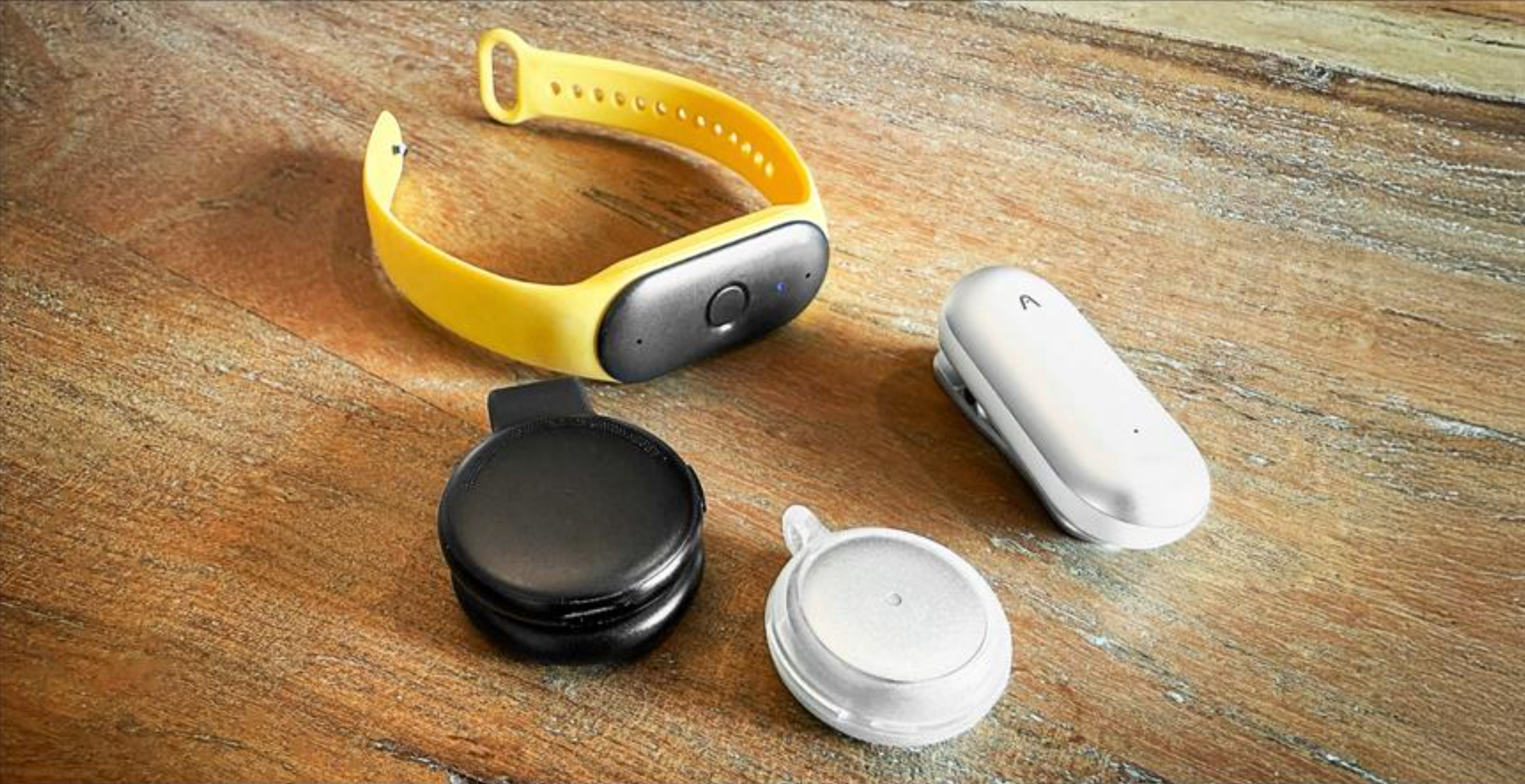 An AI pendant and an AI ring side by side, showing the two wearable form factors