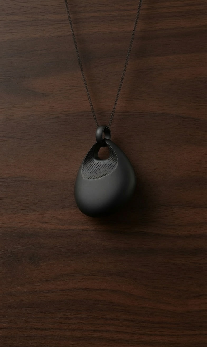 An AI pendant worn visibly at chest height, with a light indicating when it is active