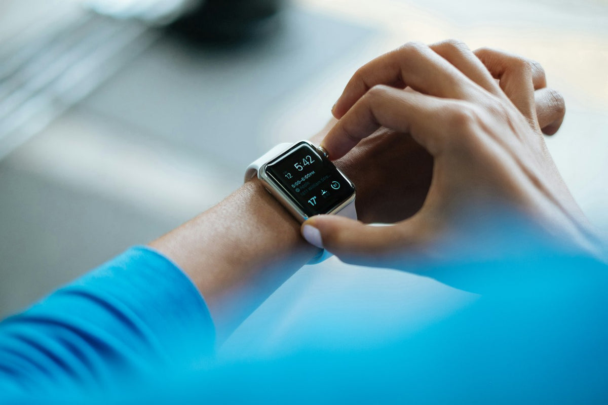 A finger on an Apple Watch Digital Crown, the control Live Rewind uses to surface the last fifteen seconds of speech