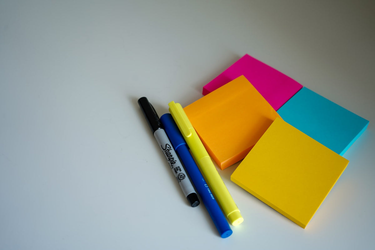 Sticky notes covering a desk, the capture system that fails first for people with ADHD