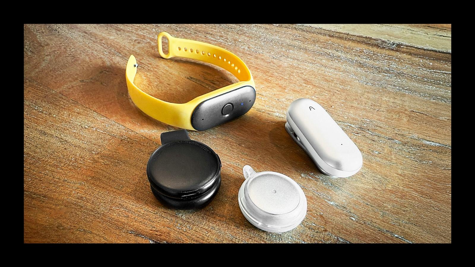 Bee, Plaud NotePin, Omi and Limitless AI wearables on a tabletop. Photo by Dave Johnson for Forbes