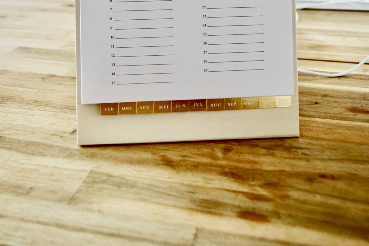 A calendar on a wooden table, the kind of scheduling job a personal AI agent is meant to take over