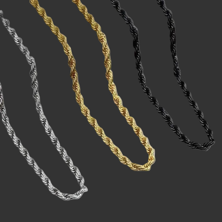 Three twisted rope chains in silver, gold, and black, arranged diagonally on a plain white background.